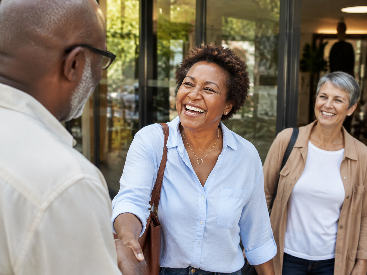 Adults greeting at a community center entrance