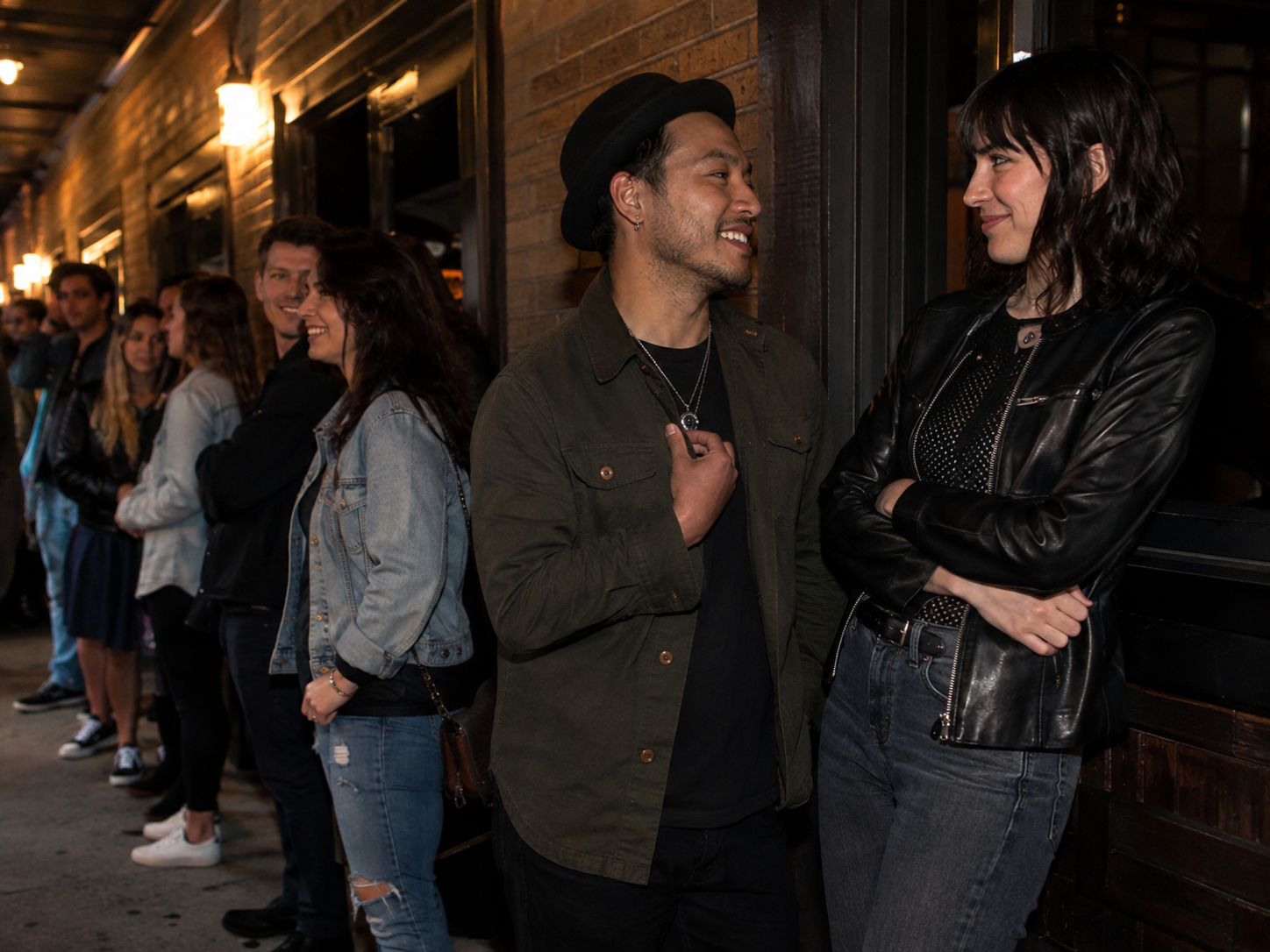 Adults waiting outside an intimate live music venue