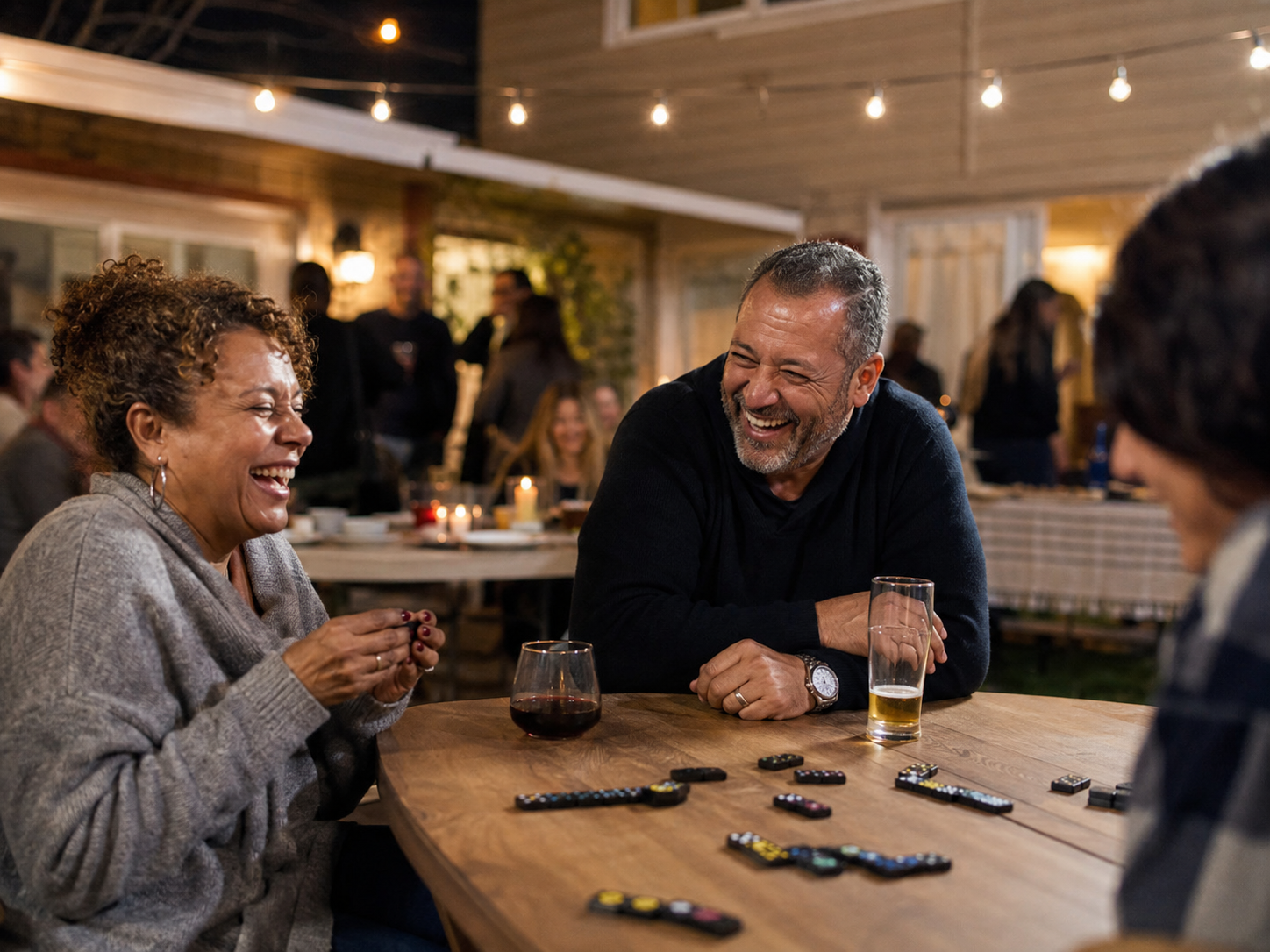 Adult couples laughing during a backyard-style community game night