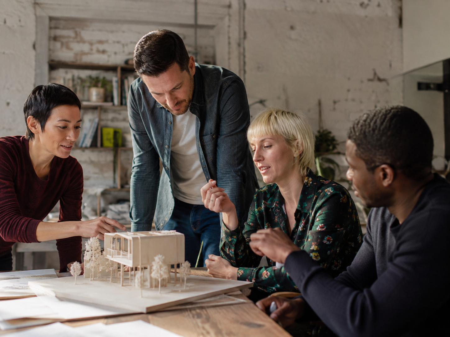 Adults discussing a prototype in a small studio