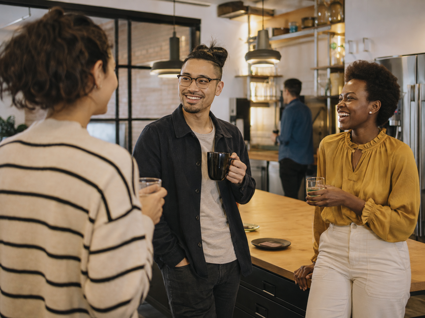 Adults meeting in a public coworking kitchen