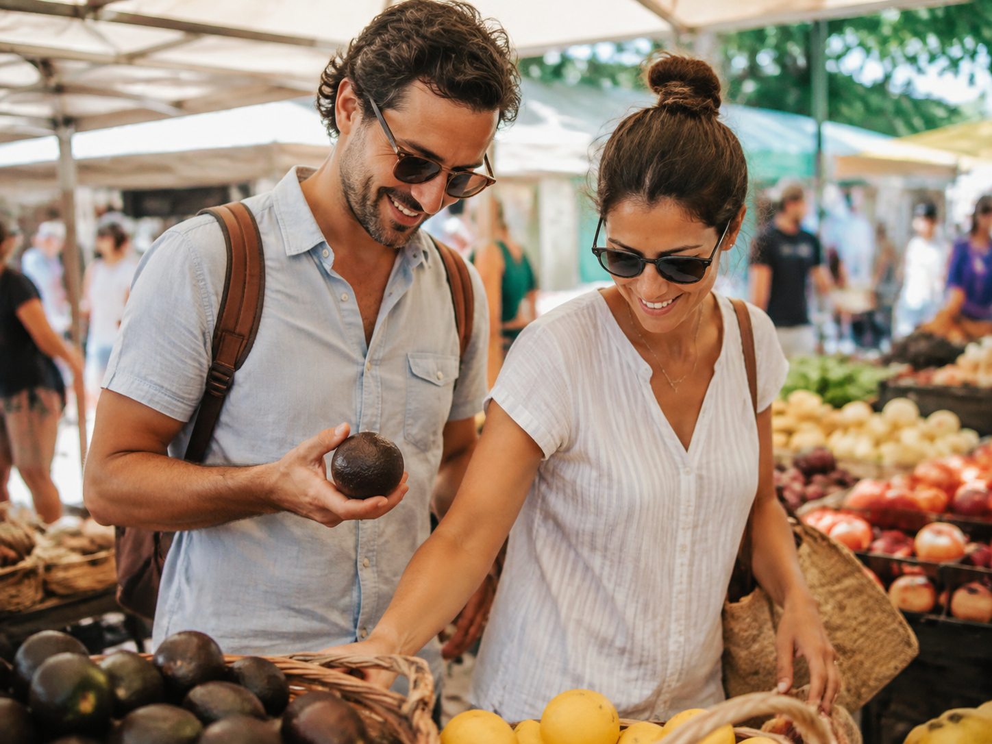 Adults choosing food at an outdoor market.