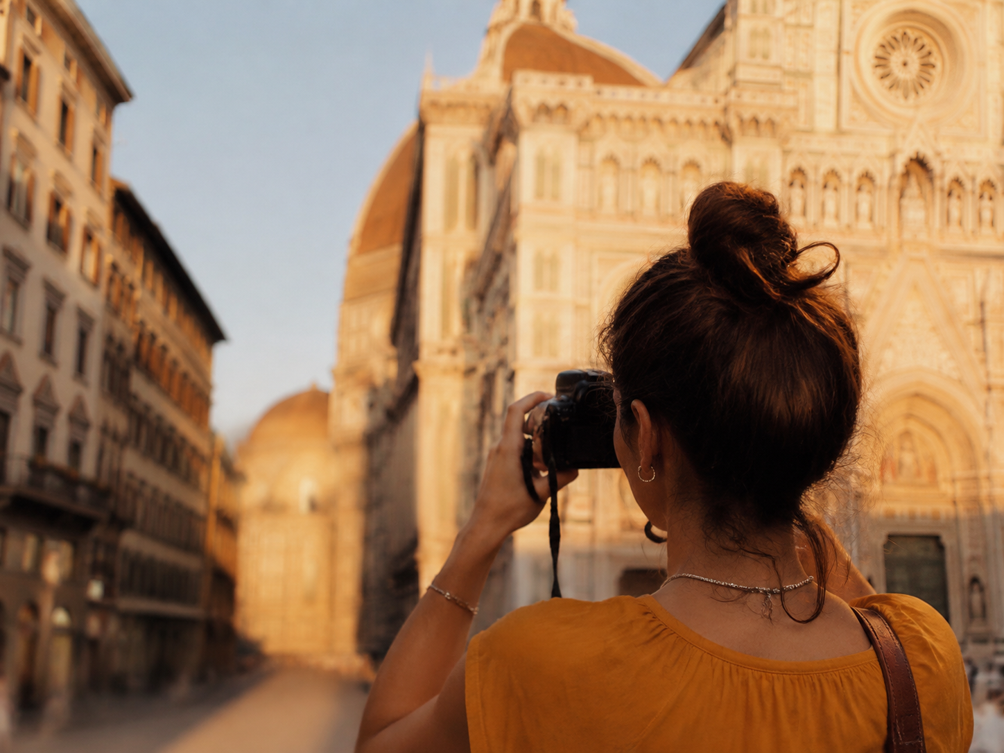 Adult taking a photograph of public architecture