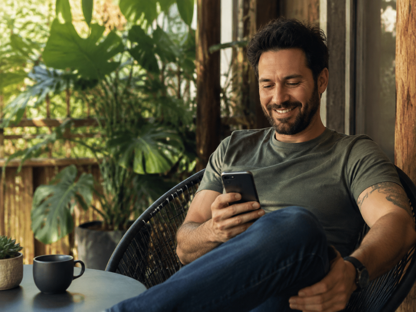 Adult checking a friendly message on a shaded porch without address details.