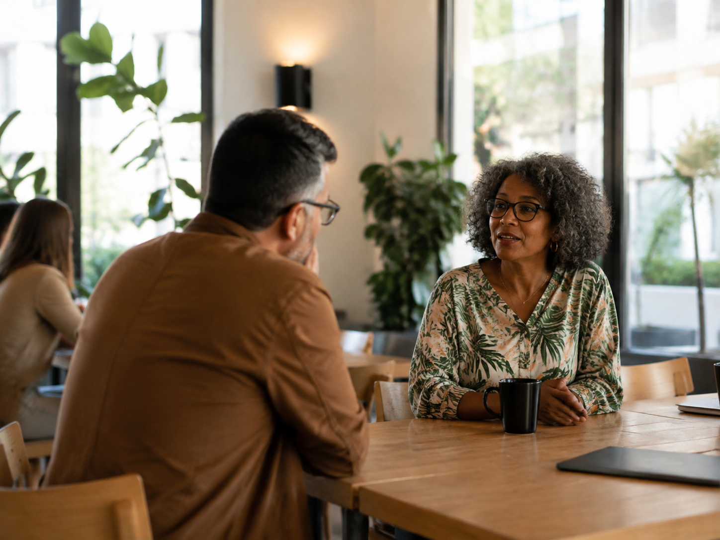 Adults chatting in a bright coworking common area