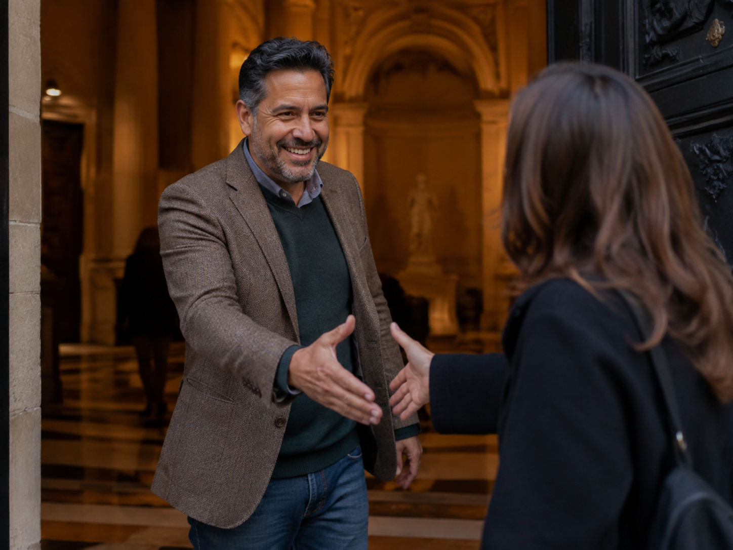 Adult greeting a new acquaintance at a museum entrance