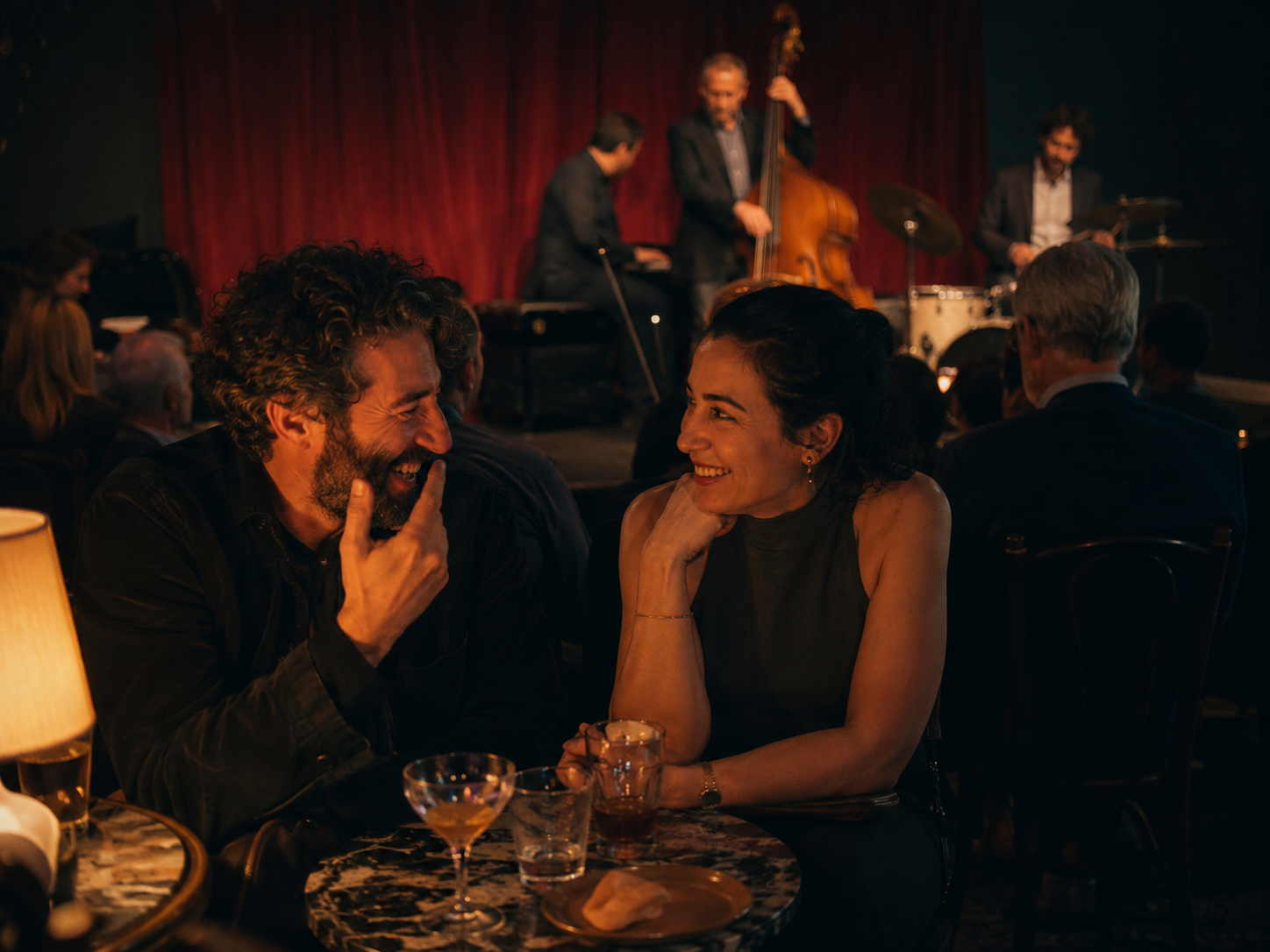 Adults enjoying live jazz at a small seated venue