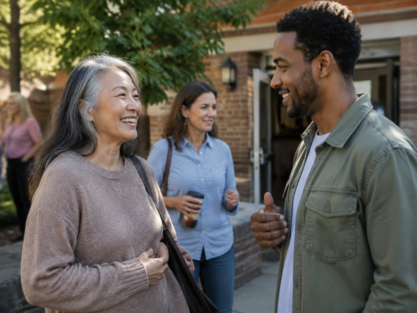 Adults greeting outside a neighborhood community center