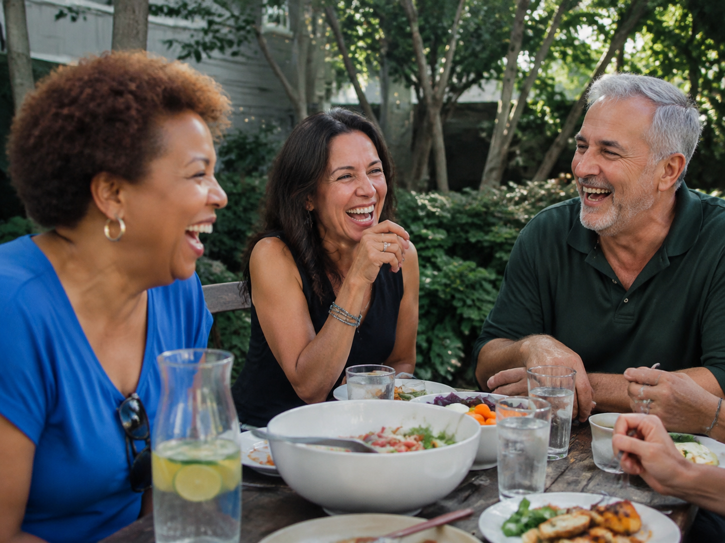 Adults laughing at a daytime neighborhood picnic table