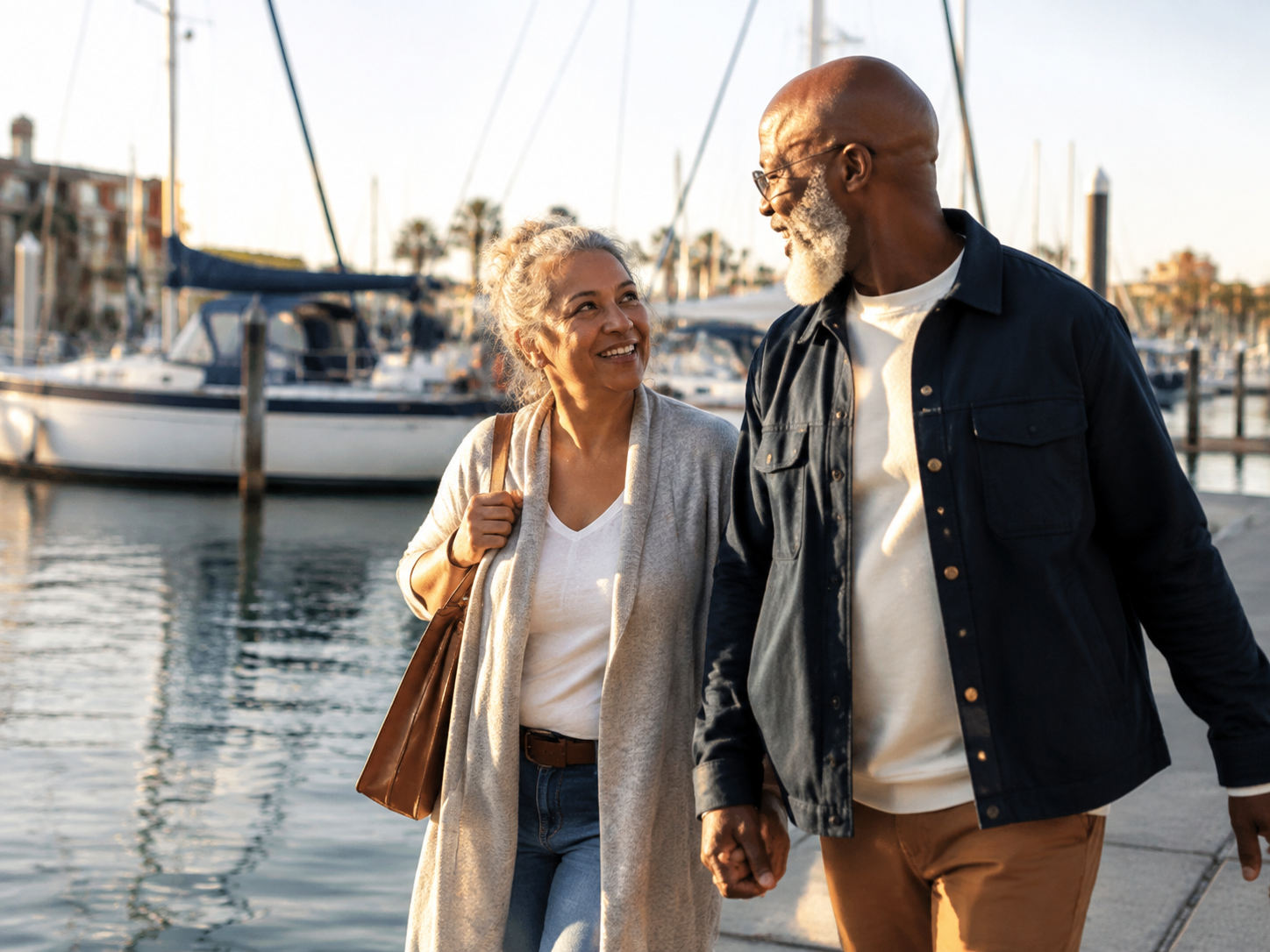 Adults smiling while walking beside a public marina